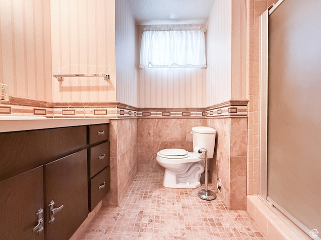 1145 E 1675 N, North Ogden, UT 84404 - bathroom featuring wallpapered walls, toilet, a stall shower, wainscoting, and tile patterned floors