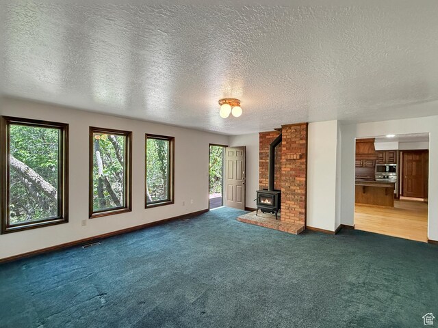 1145 E 1675 N, North Ogden, UT 84404 - unfurnished living room with healthy amount of natural light, a wood stove, carpet, and a textured ceiling