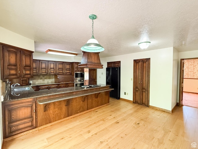 1145 E 1675 N, North Ogden, UT 84404 - kitchen with stainless steel appliances, a peninsula, a sink, a textured ceiling, and light wood-style floors