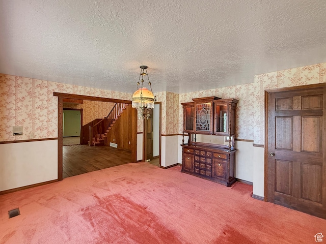 1145 E 1675 N, North Ogden, UT 84404 - carpeted empty room featuring wallpapered walls, a chandelier, a textured ceiling, stairs, and baseboards