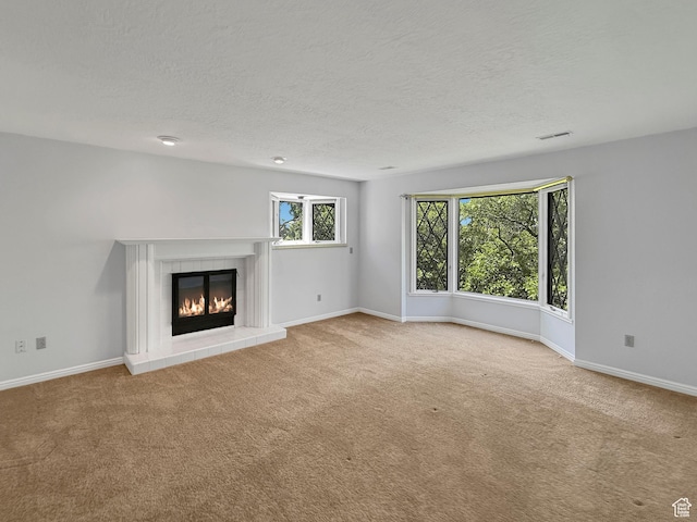 1145 E 1675 N, North Ogden, UT 84404 - unfurnished living room featuring carpet floors, a tile fireplace, baseboards, and a textured ceiling