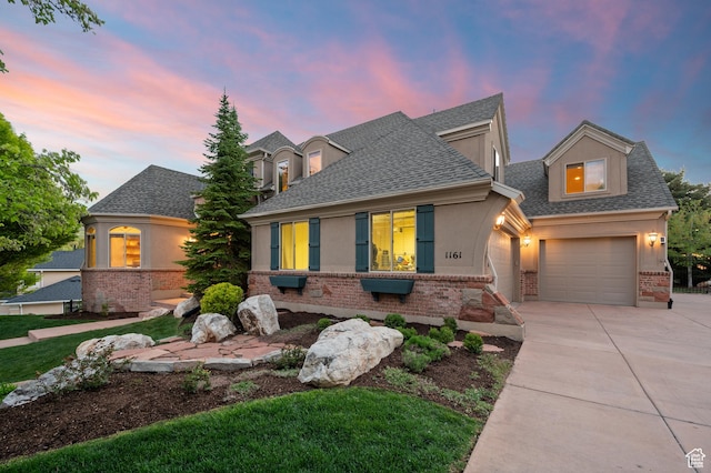 1161 Woodcrest Ln, North Salt Lake, UT 84054 - view of front of house with brick siding, a shingled roof, driveway, and an attached garage