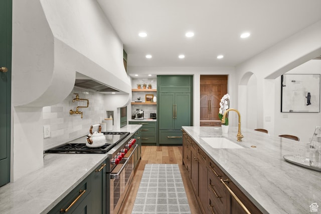 1161 Woodcrest Ln, North Salt Lake, UT 84054 - kitchen with high quality appliances, a sink, green cabinets, backsplash, and recessed lighting