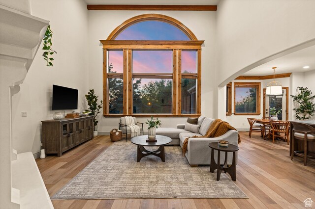 1161 Woodcrest Ln, North Salt Lake, UT 84054 - living area with arched walkways, wood-type flooring, and a towering ceiling