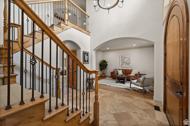 1161 Woodcrest Ln, North Salt Lake, UT 84054 - stairway featuring arched walkways, baseboards, ornamental molding, a high ceiling, and recessed lighting