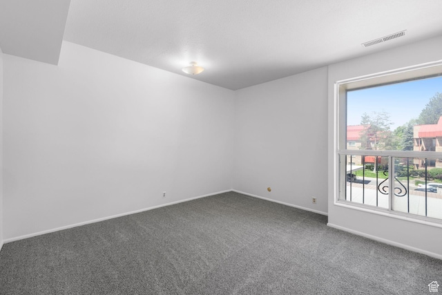 4878 S Highland Cir Unit 6, Salt Lake City, UT 84117 - spare room featuring dark colored carpet and baseboards