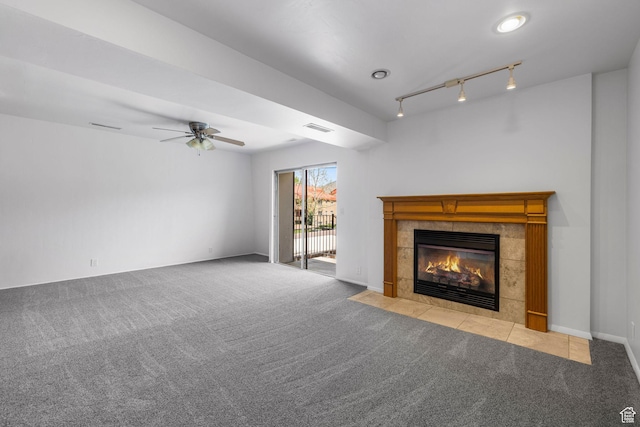 4878 S Highland Cir Unit 6, Salt Lake City, UT 84117 - unfurnished living room with carpet, track lighting, ceiling fan, and a tiled fireplace
