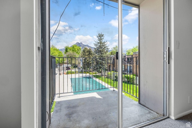 4878 S Highland Cir Unit 6, Salt Lake City, UT 84117 - doorway featuring healthy amount of natural light and a mountain view
