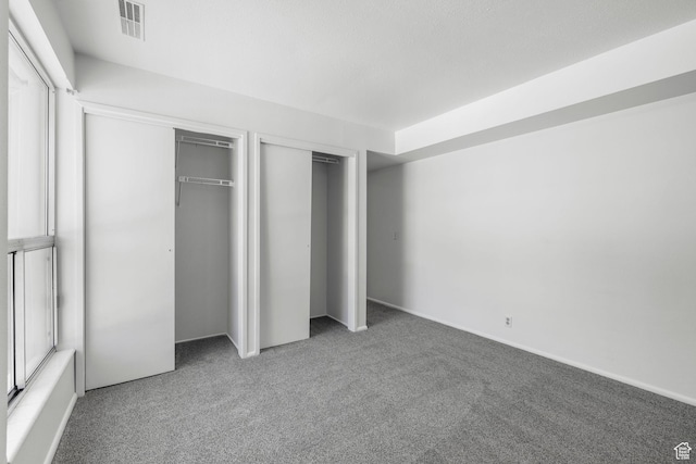 4878 S Highland Cir Unit 6, Salt Lake City, UT 84117 - unfurnished bedroom with multiple closets and carpet flooring