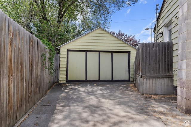 detached garage with driveway and fence