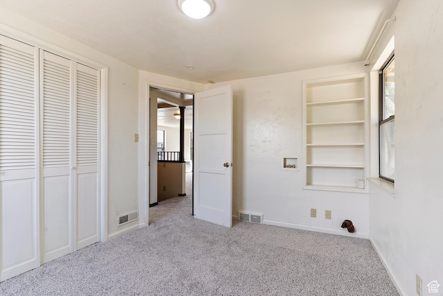 unfurnished bedroom featuring carpet floors, baseboards, and a closet