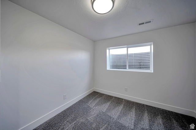 5775 S Brandy Wine S, Taylorsville, UT 84129 - spare room with baseboards, dark colored carpet, and a textured ceiling