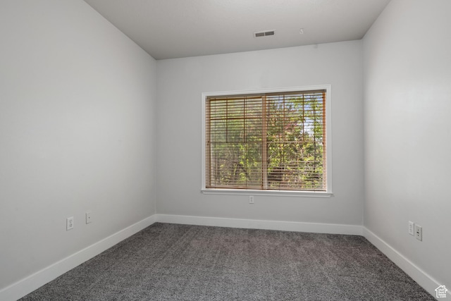 spare room with carpet flooring and baseboards
