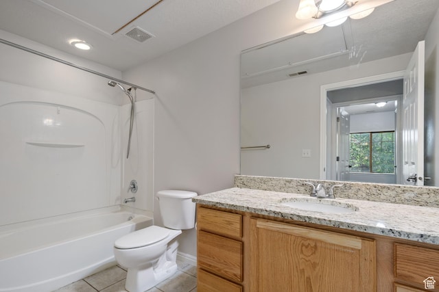 bathroom featuring toilet, vanity, tile patterned flooring, shower / tub combination, and baseboards