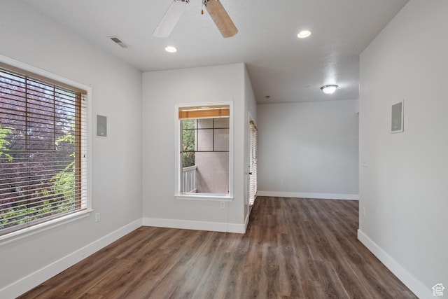spare room featuring healthy amount of natural light, wood finished floors, baseboards, and recessed lighting