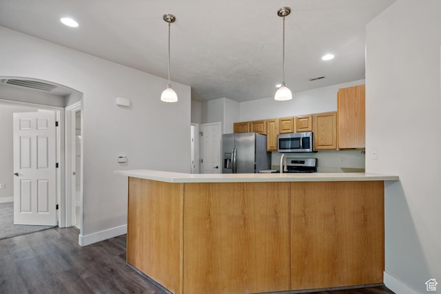 kitchen featuring appliances with stainless steel finishes, dark wood-style flooring, baseboards, arched walkways, and recessed lighting