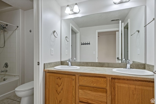 bathroom featuring tile patterned flooring, toilet, double vanity, and tub / shower combination