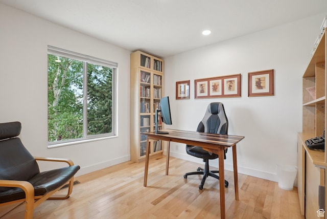 office space featuring baseboards, light wood-style flooring, and recessed lighting