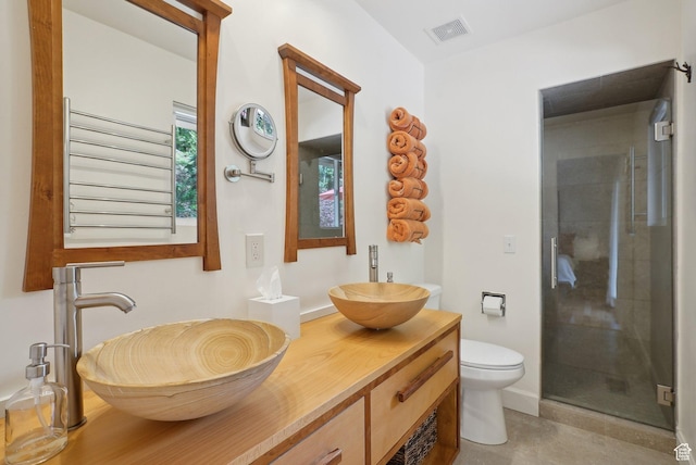 full bath with a shower stall, toilet, vanity, and baseboards