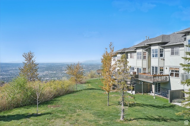 view of grassy yard with a wooden deck