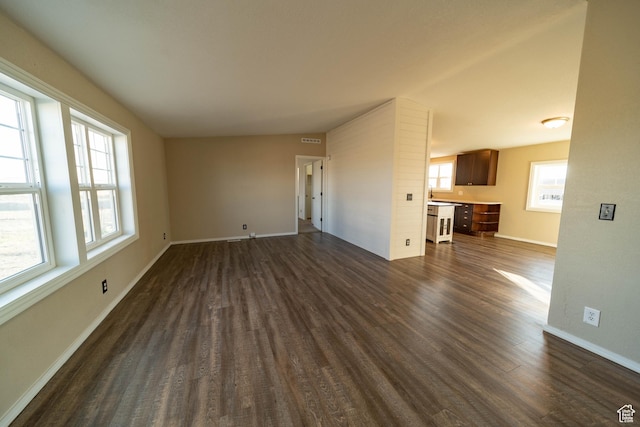 1691 E 8900 S, Price, UT 84501 - unfurnished living room with dark wood-type flooring and baseboards