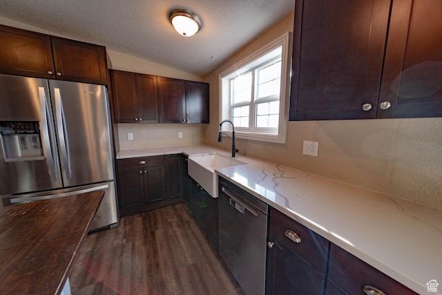 1691 E 8900 S, Price, UT 84501 - kitchen featuring appliances with stainless steel finishes, a sink, dark wood finished floors, vaulted ceiling, and light stone counters