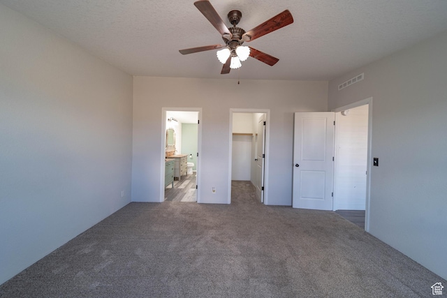 1691 E 8900 S, Price, UT 84501 - unfurnished bedroom with carpet, a walk in closet, ceiling fan, a closet, and connected bathroom