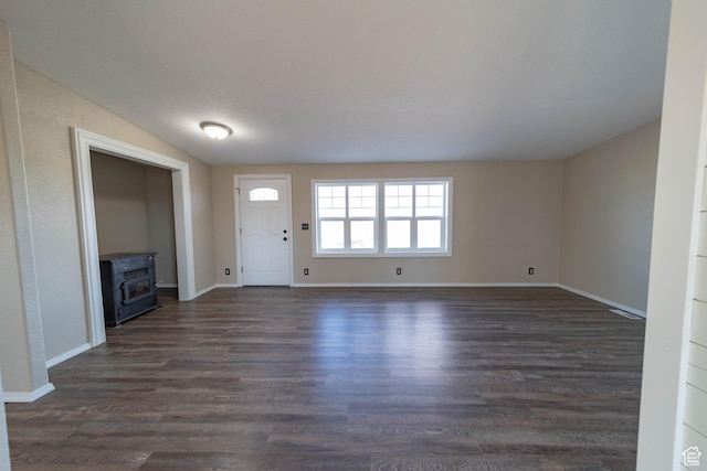 1691 E 8900 S, Price, UT 84501 - foyer entrance with a wood stove, dark wood-style floors, and baseboards