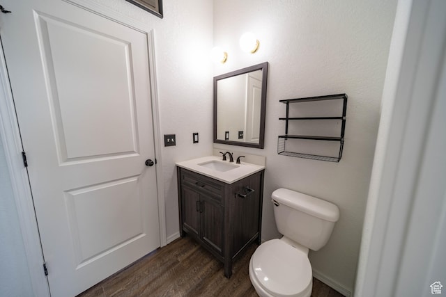 1691 E 8900 S, Price, UT 84501 - half bathroom featuring vanity, toilet, and wood finished floors