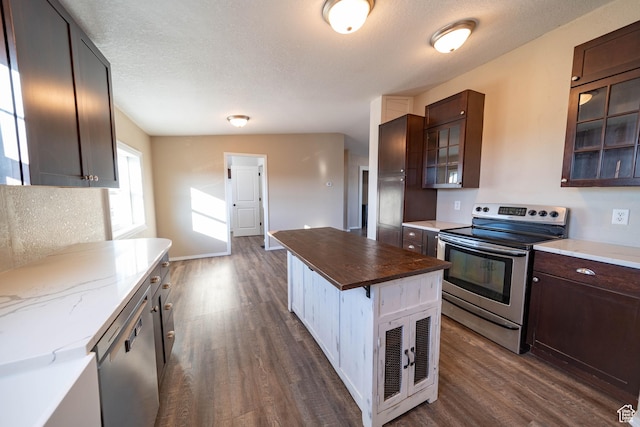 1691 E 8900 S, Price, UT 84501 - kitchen featuring appliances with stainless steel finishes, dark wood-style flooring, glass insert cabinets, dark brown cabinets, and a textured ceiling