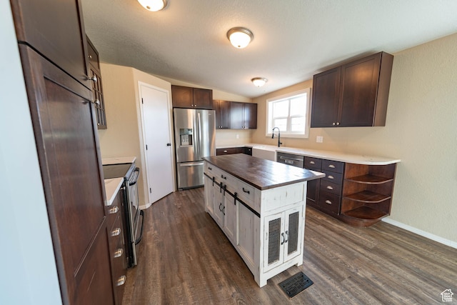 1691 E 8900 S, Price, UT 84501 - kitchen featuring appliances with stainless steel finishes, a sink, wood counters, dark brown cabinetry, and dark wood-style floors