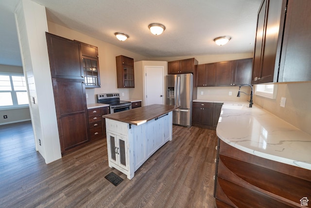1691 E 8900 S, Price, UT 84501 - kitchen featuring stainless steel appliances, dark wood-style flooring, butcher block counters, a sink, and a center island
