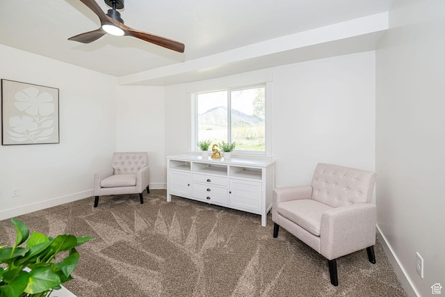living area with carpet, a ceiling fan, and baseboards