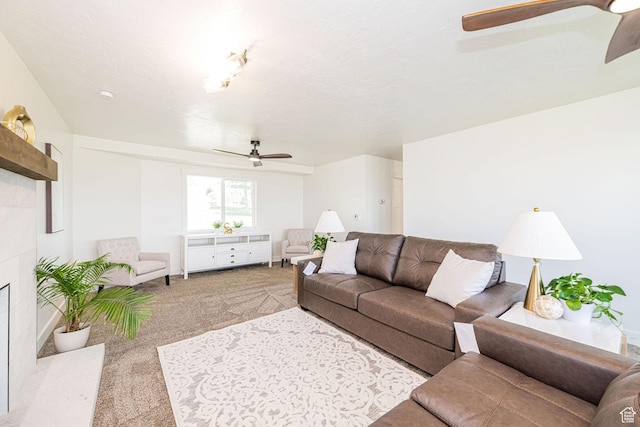 carpeted living area featuring ceiling fan