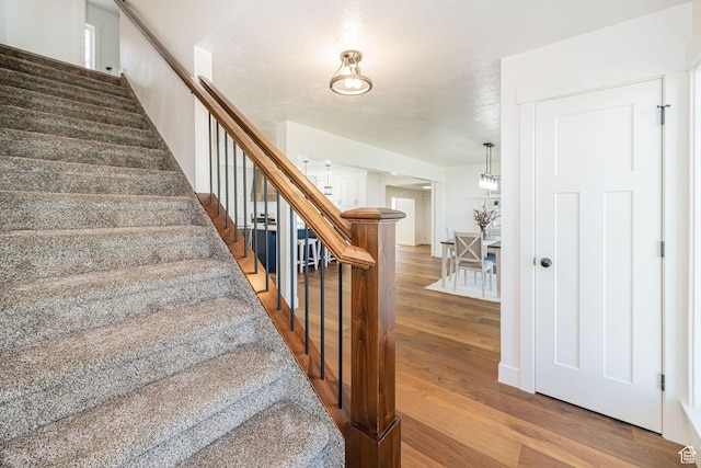 stairway with wood finished floors