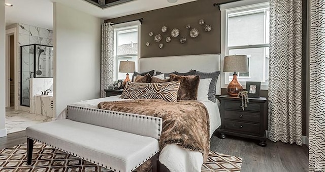 bedroom with wood finished floors and ensuite bathroom