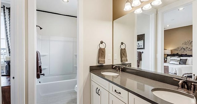 bathroom featuring ensuite bath, double vanity, shower / bathtub combination, toilet, and recessed lighting