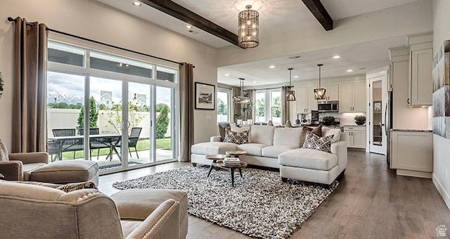 living room featuring beam ceiling, dark wood-style floors, and recessed lighting