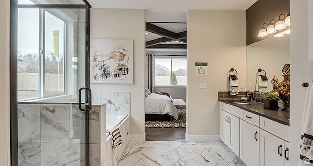 bathroom featuring a stall shower, ensuite bath, marble look tiles, vanity, and baseboards