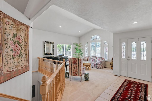 foyer entrance with lofted ceiling, light carpet, light tile patterned floors, recessed lighting, and baseboards