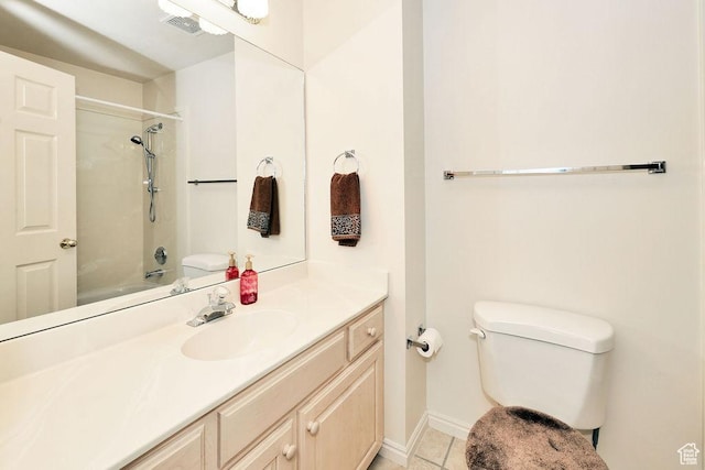 bathroom featuring toilet, vanity, tile patterned floors, tub / shower combination, and baseboards