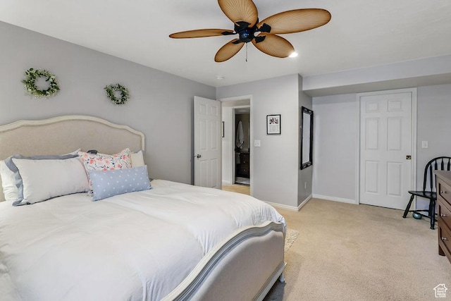 bedroom featuring light colored carpet, ceiling fan, and baseboards