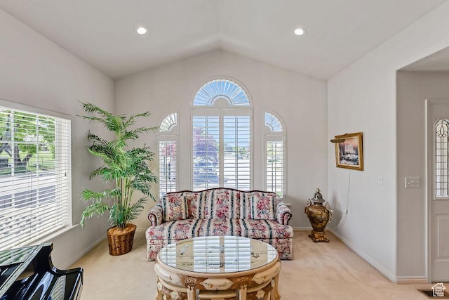 living area with light colored carpet, healthy amount of natural light, vaulted ceiling, baseboards, and recessed lighting