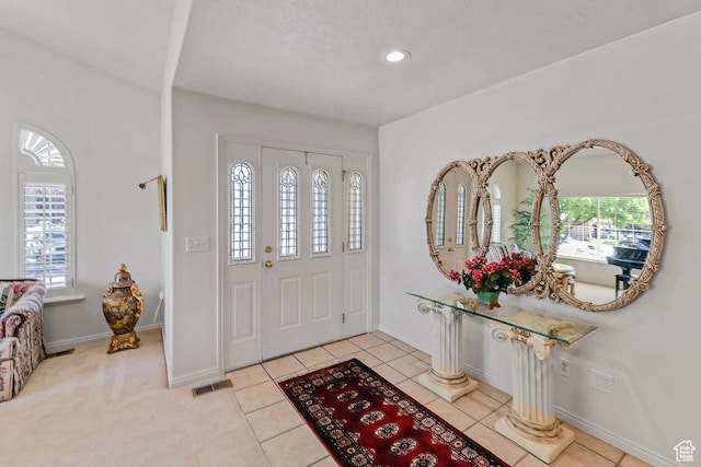 foyer with light tile patterned floors, baseboards, and recessed lighting