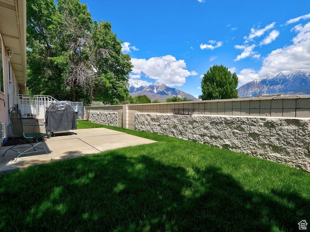 view of yard with a mountain view and a patio