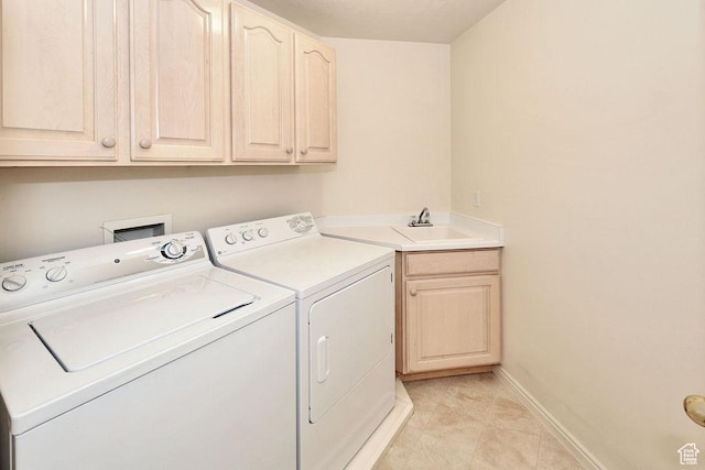 laundry area with independent washer and dryer, cabinet space, baseboards, and light tile patterned floors