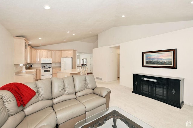 living room with lofted ceiling, light colored carpet, and recessed lighting