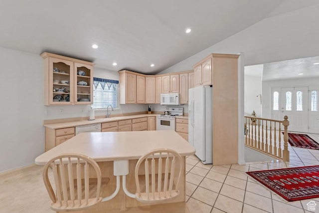 kitchen featuring white appliances, light brown cabinets, light countertops, glass insert cabinets, and vaulted ceiling