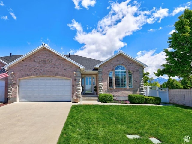 view of front of home with brick siding, an attached garage, and driveway