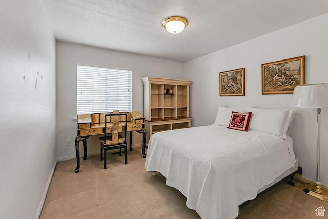 bedroom featuring light colored carpet and baseboards